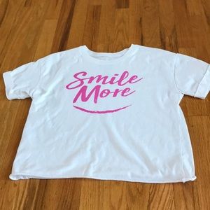 white and pink “smile more” t shirt